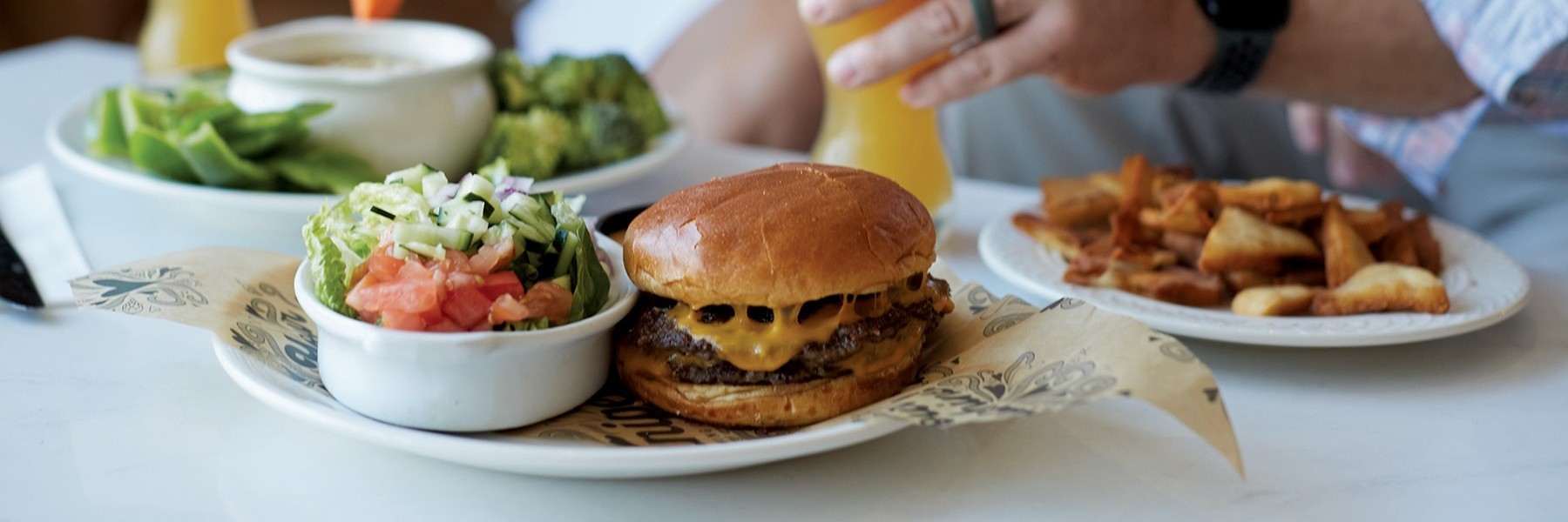 Family walking next to a mural wall with artwork on it.
