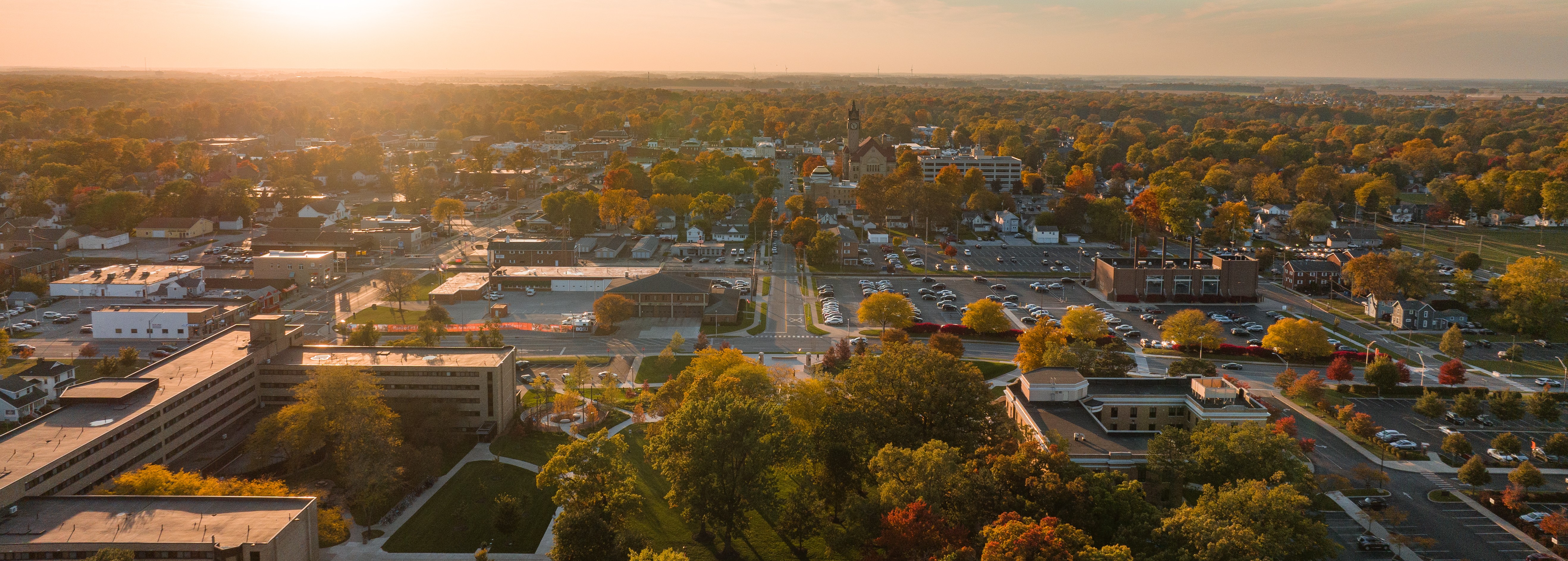 Family walking next to a mural wall with artwork on it.