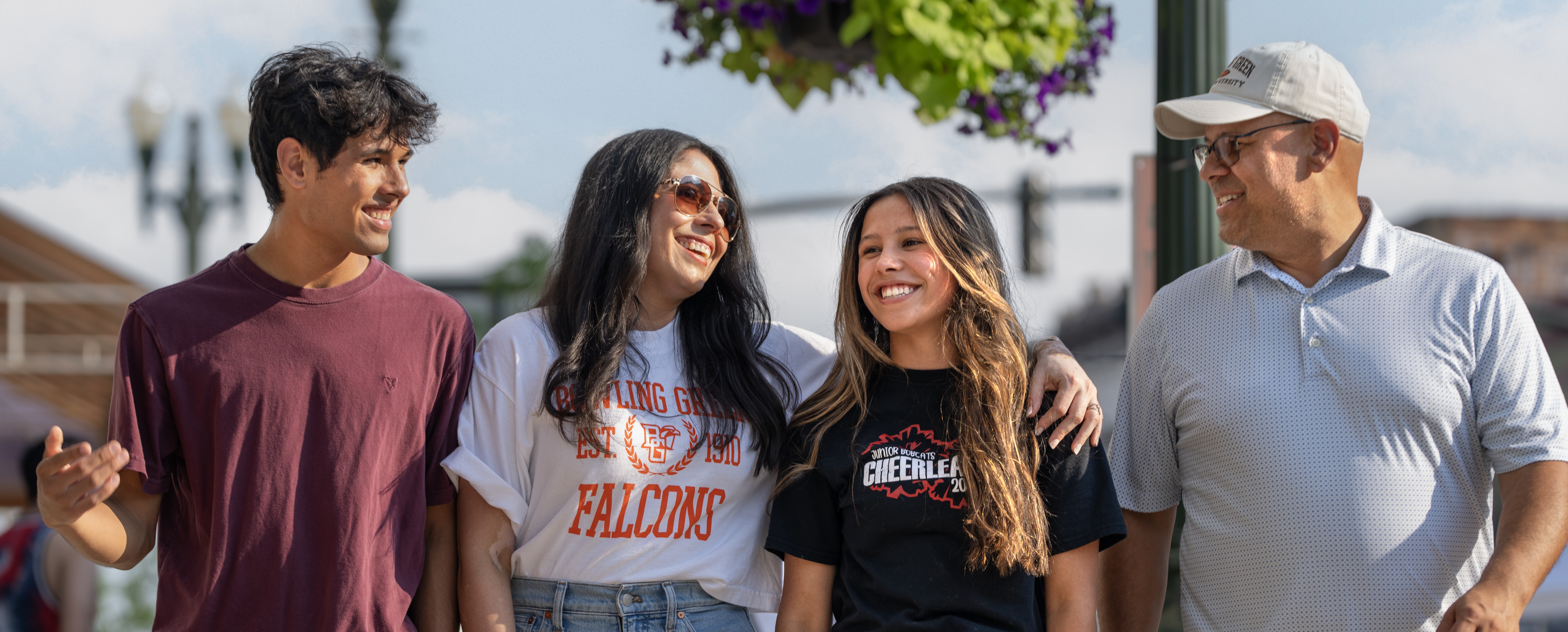 Family walking next to a mural wall with artwork on it.